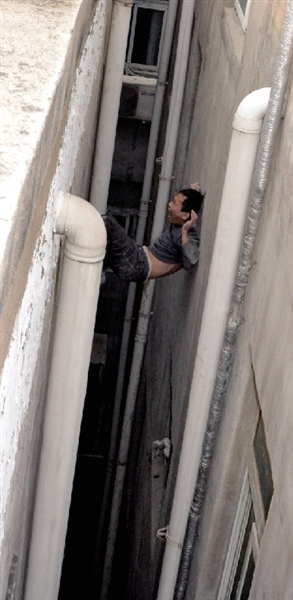 就在民警緊急施救時(shí)，他從兩樓之間摔下。