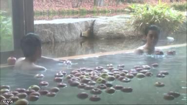 一個(gè)個(gè)蘋果漂浮在浴槽內(nèi)（NHK網(wǎng)頁截圖）。